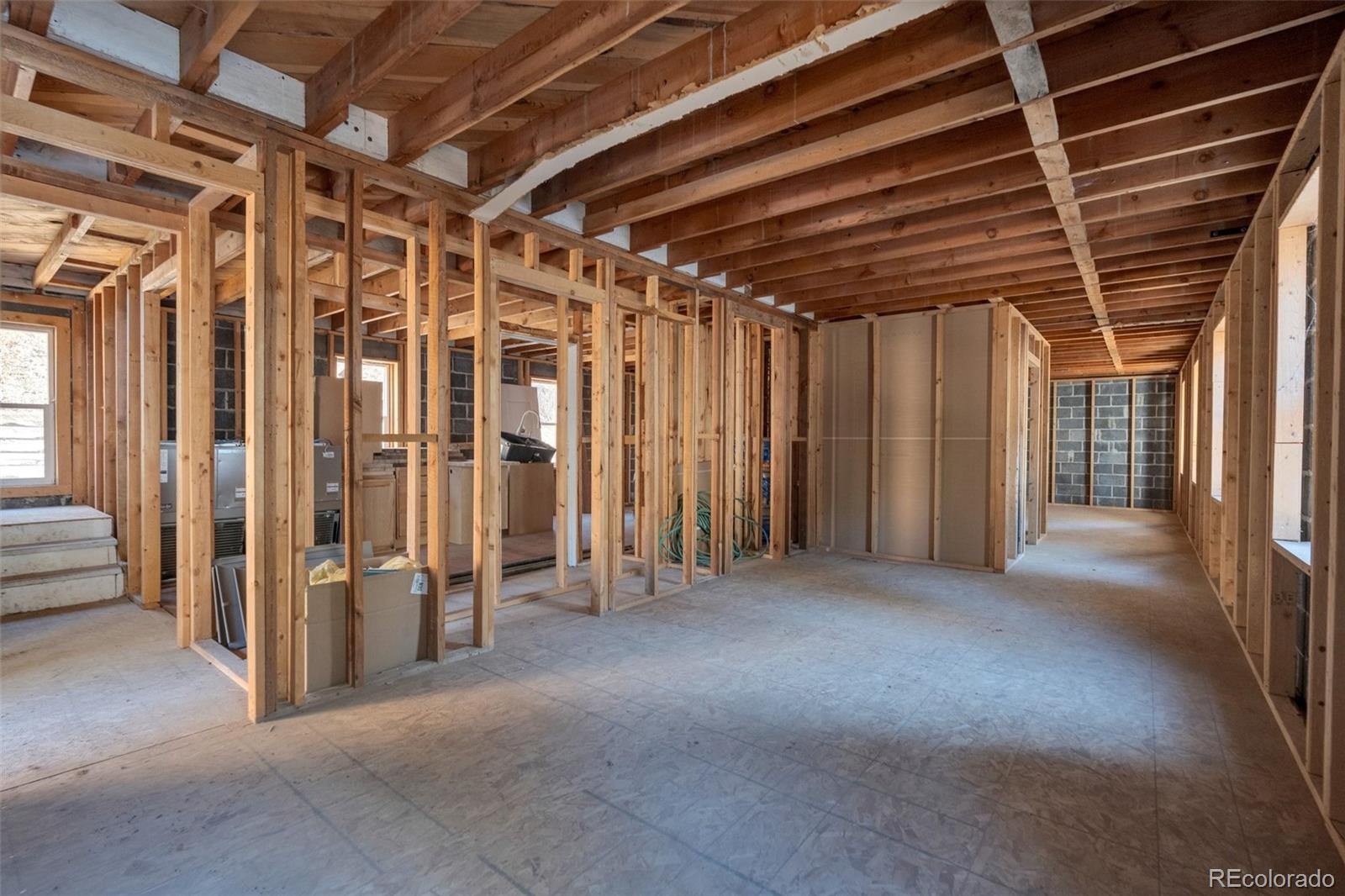 1906 Hidden Valley Road Sedalia, CO 80135 - Photo 8 of 27 a view of empty room with wooden walls
