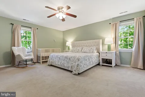 a bedroom with a bed a chair and a window