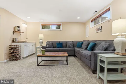 a living room with furniture and painting on the wall