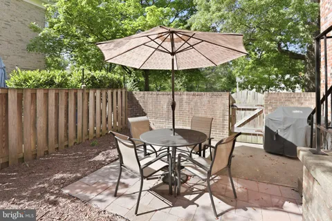 a patio with a patio table and chairs