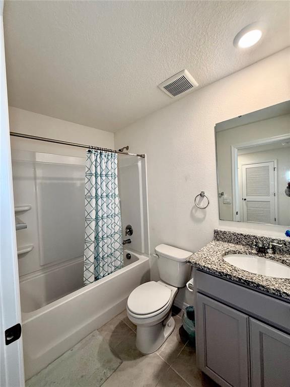 6576 Druid Way Harmony, FL 34773 - Photo 12 of 16 a bathroom with a granite countertop sink toilet a mirror and shower