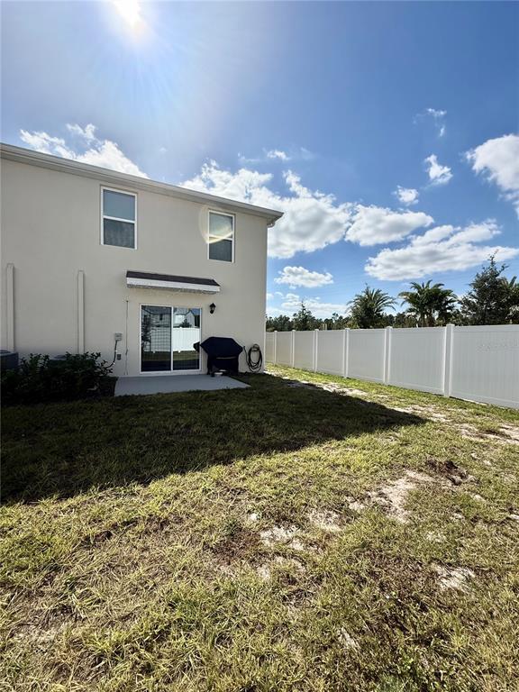 6576 Druid Way Harmony, FL 34773 - Photo 16 of 16 a view of a house with backyard and garden