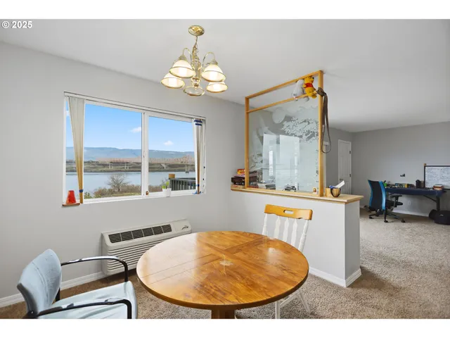 a view of a dining room with furniture and a chandelier