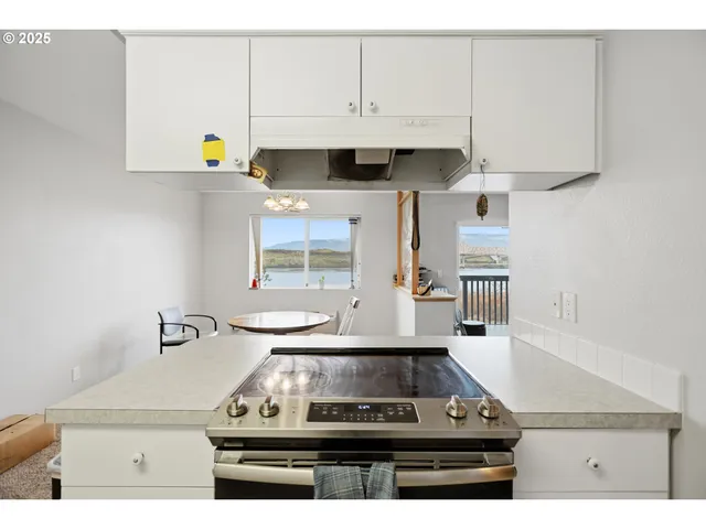 a kitchen with a stove and cabinets
