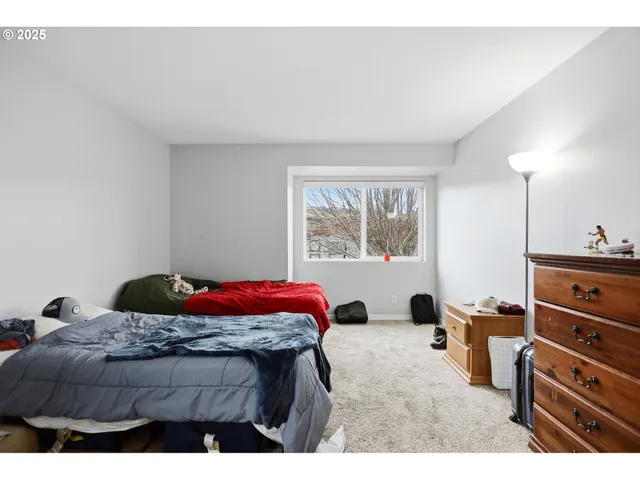 a bedroom with a bed and a dresser