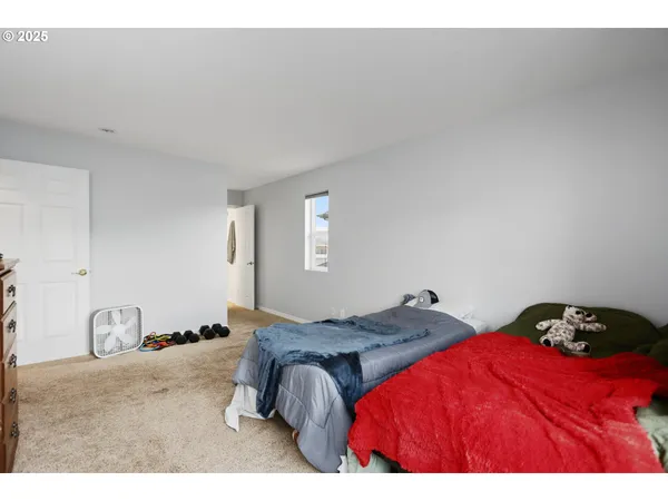 a bedroom with a bed and a lamp