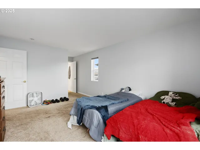 a bedroom with a bed and a lamp