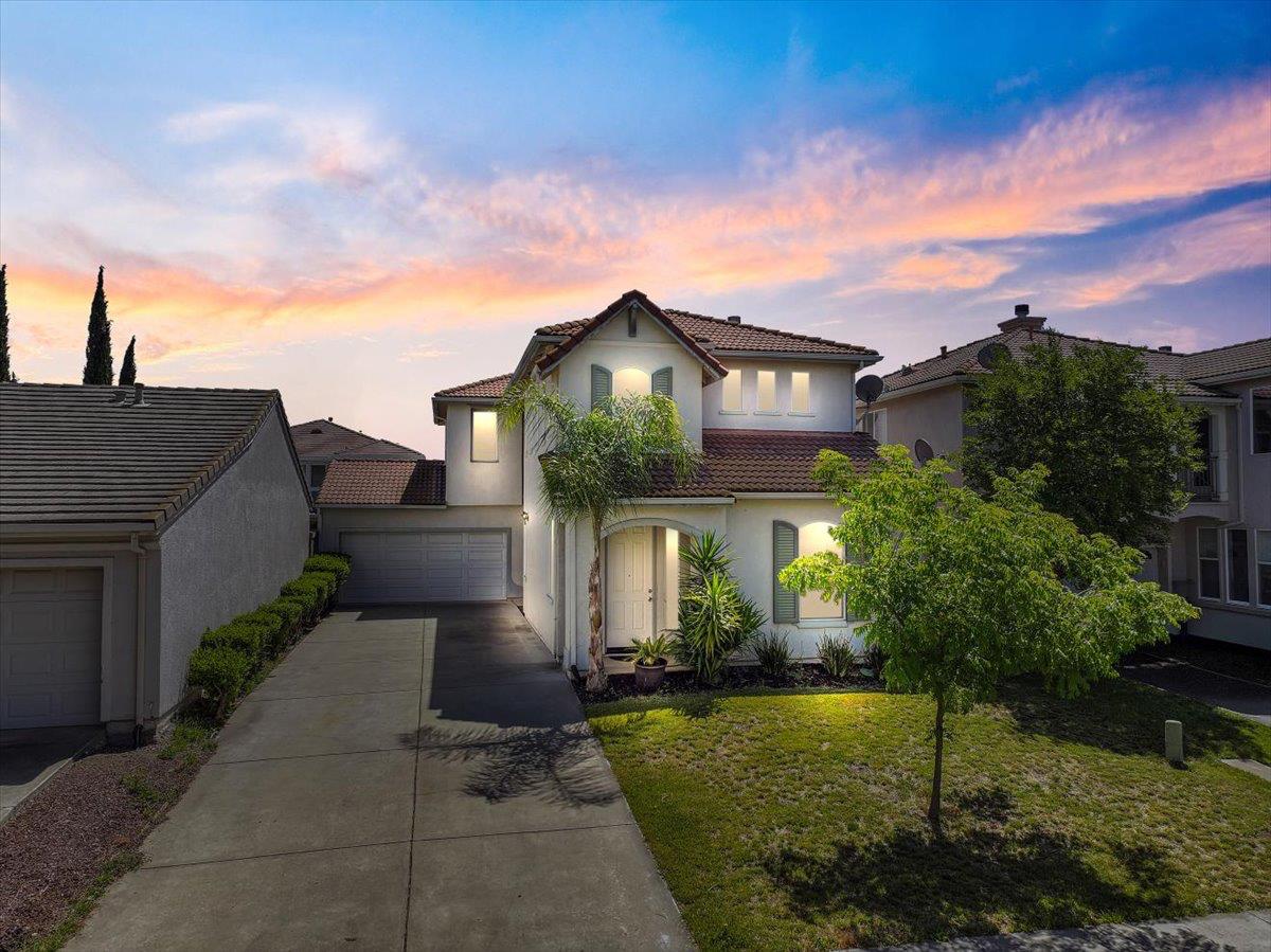 a front view of a house with a garden