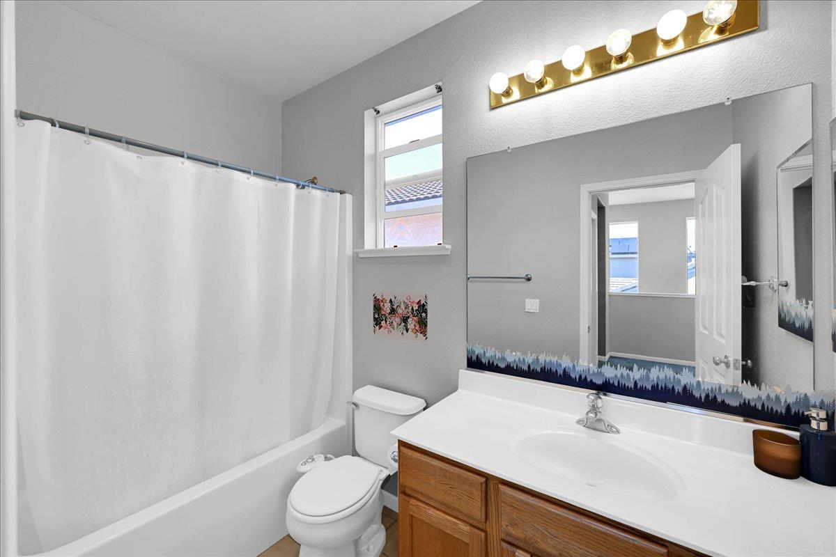 341 Barnhart Circle Sacramento, CA 95835 - Photo 27 of 55 a bathroom with a sink a toilet and shower curtain