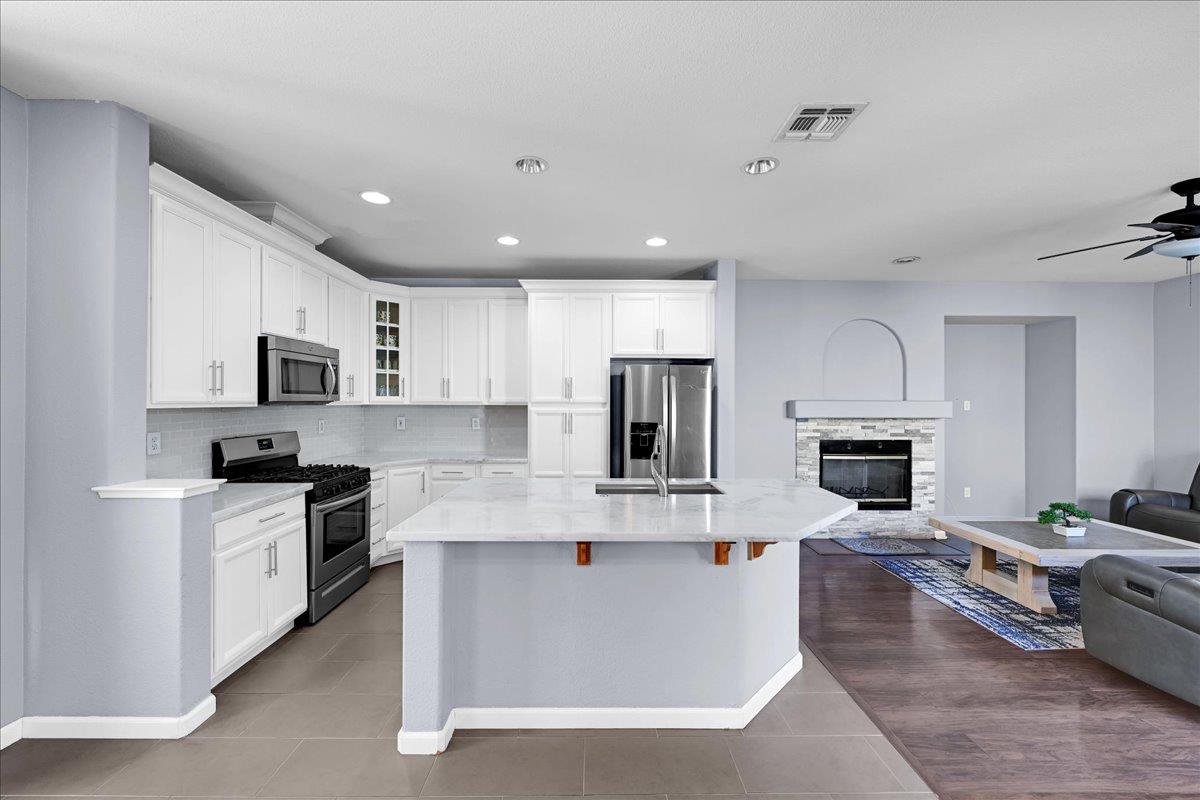 341 Barnhart Circle Sacramento, CA 95835 - Photo 4 of 55 a large white kitchen with stainless steel appliances