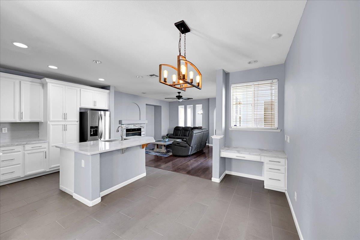 341 Barnhart Circle Sacramento, CA 95835 - Photo 8 of 55 a kitchen that has a lot of white cabinets and stainless steel appliances
