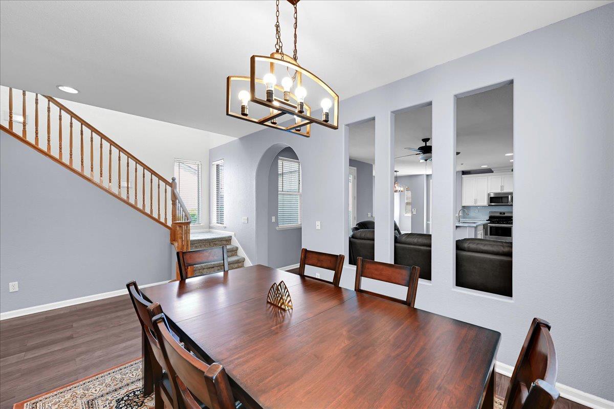 341 Barnhart Circle Sacramento, CA 95835 - Photo 10 of 55 a view of a dining room with furniture a chandelier and wooden floor