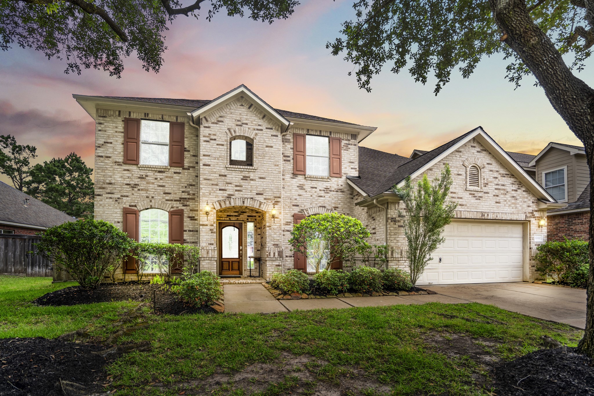 10410 Pitcataway Drive Spring, TX 77379 - Photo 1 of 48 Welcome to 10410 Pitcataway Drive a traditional two-story brick home that perfectly blends classic charm set against the backdrop of a breathtaking Texas sunset.