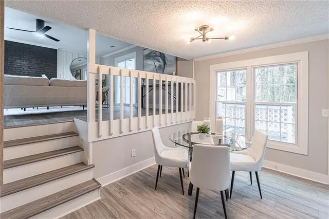 a dining room with furniture a chandelier and wooden floor