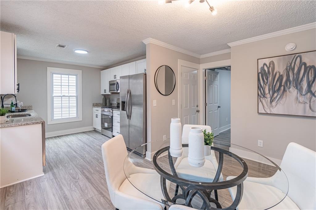 5367 Rails Way Norcross, GA 30071 - Photo 13 of 35 a view of a dining room with furniture window and wooden floor