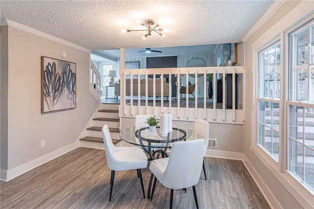 a view of a dining room with furniture window and wooden floor