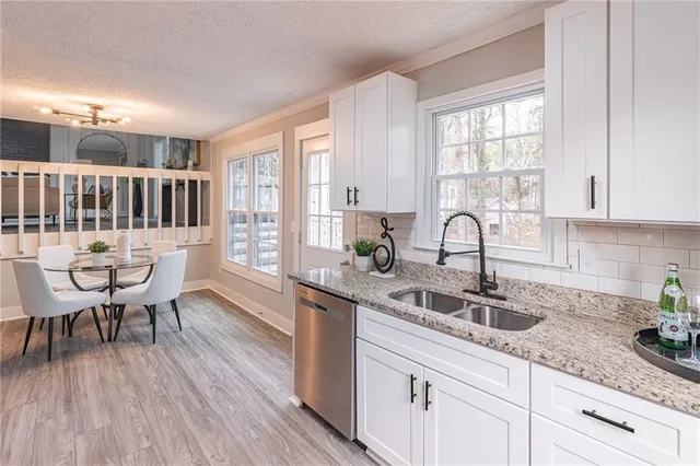 a kitchen with sink cabinets and dining table