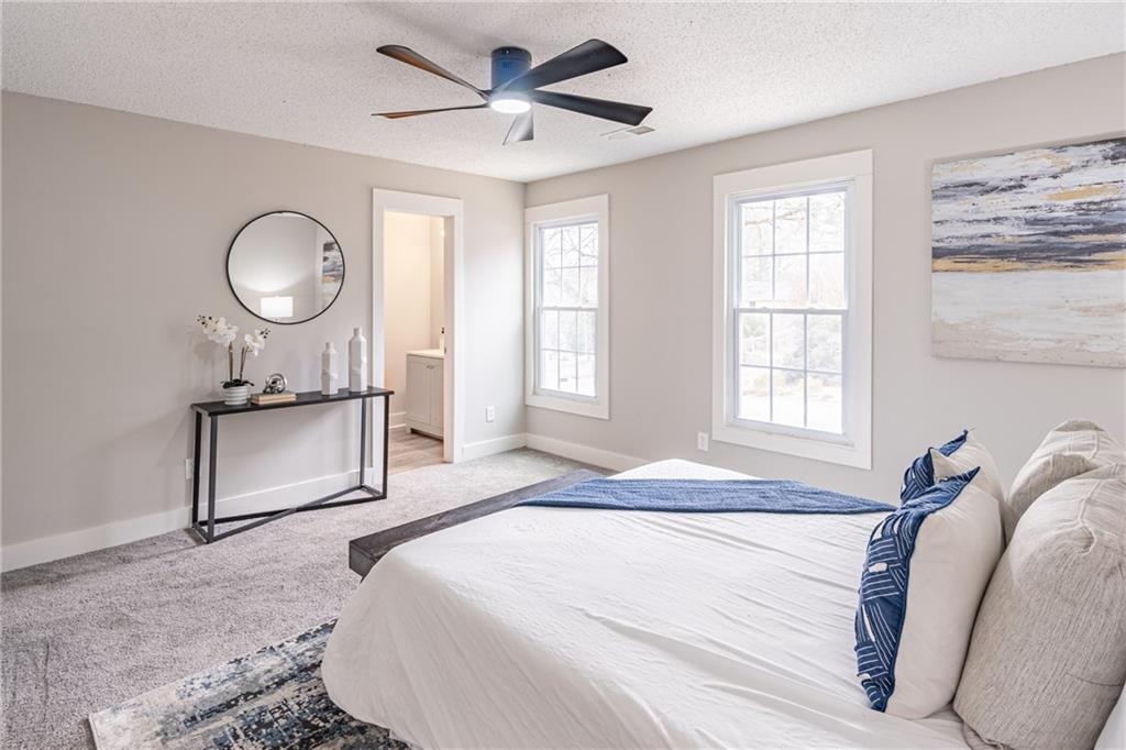 5367 Rails Way Norcross, GA 30071 - Photo 22 of 35 a bedroom with a bed mirror and a window