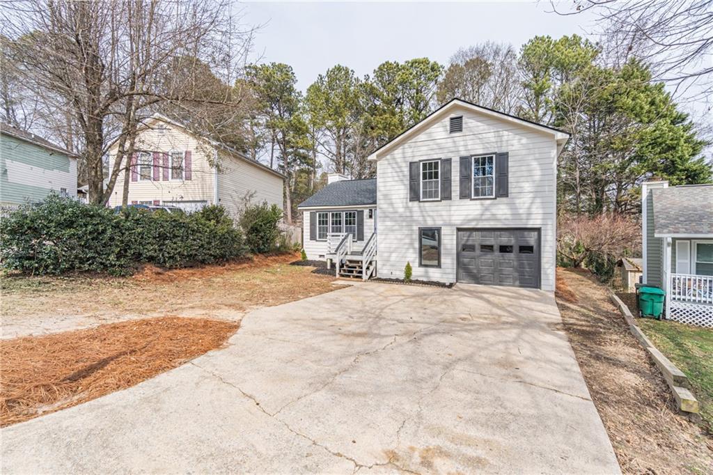 5367 Rails Way Norcross, GA 30071 - Photo 3 of 35 a front view of a house with a yard and potted plants