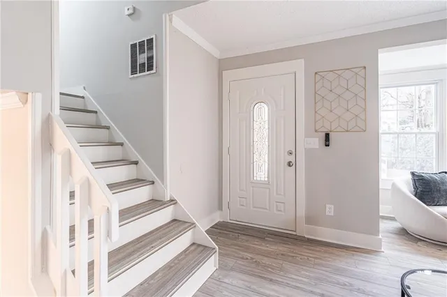 a view of entryway with wooden floor and stairs