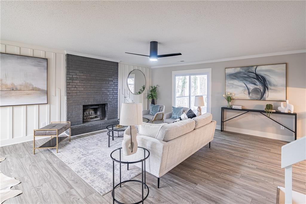 5367 Rails Way Norcross, GA 30071 - Photo 6 of 35 a living room with furniture a fireplace and a flat screen tv