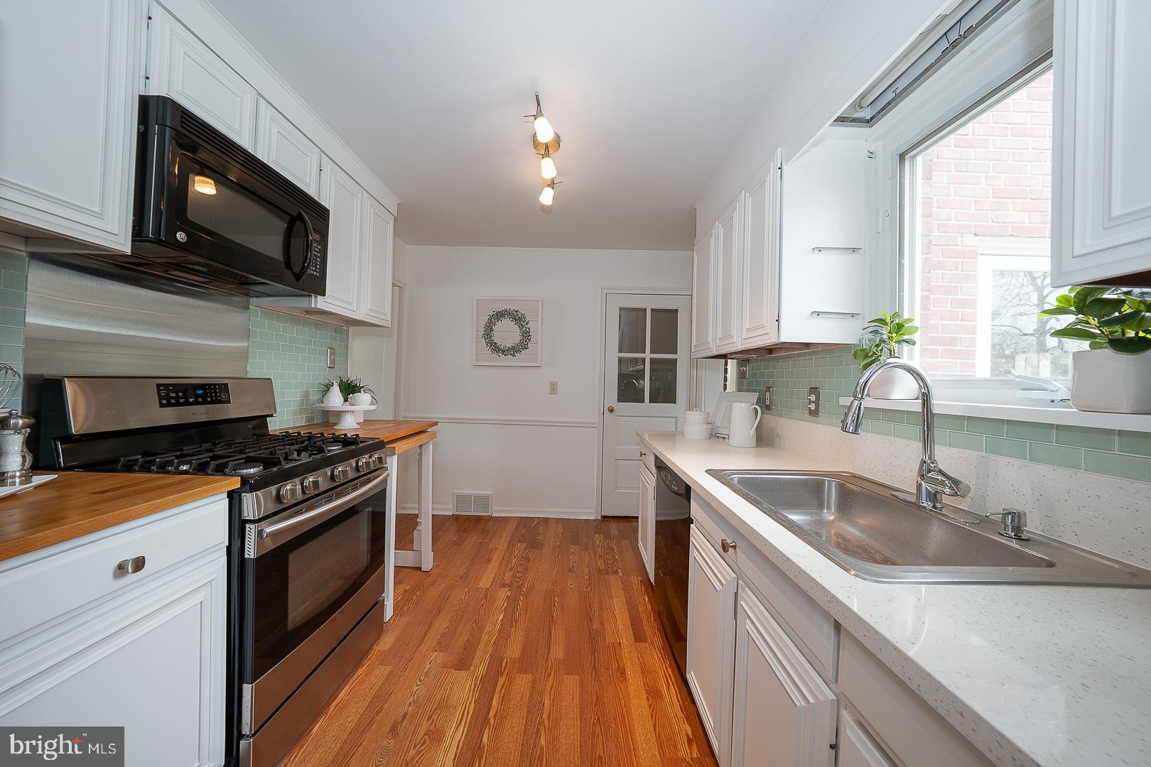 298 Strafford Avenue Wayne, PA 19087 - Photo 12 of 41 a kitchen with stainless steel appliances granite countertop a sink stove and microwave