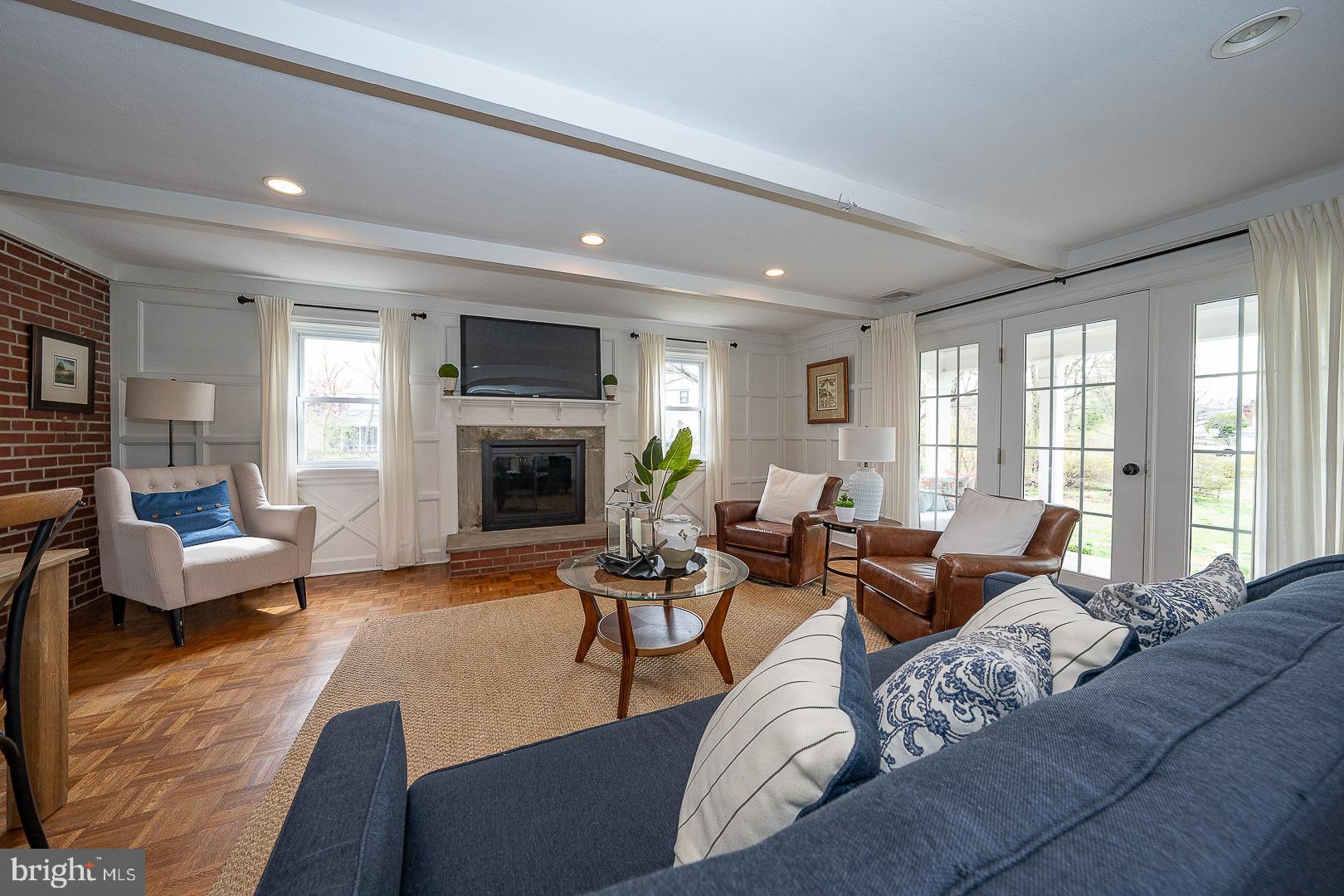 298 Strafford Avenue Wayne, PA 19087 - Photo 16 of 41 a living room with furniture large window and a fireplace