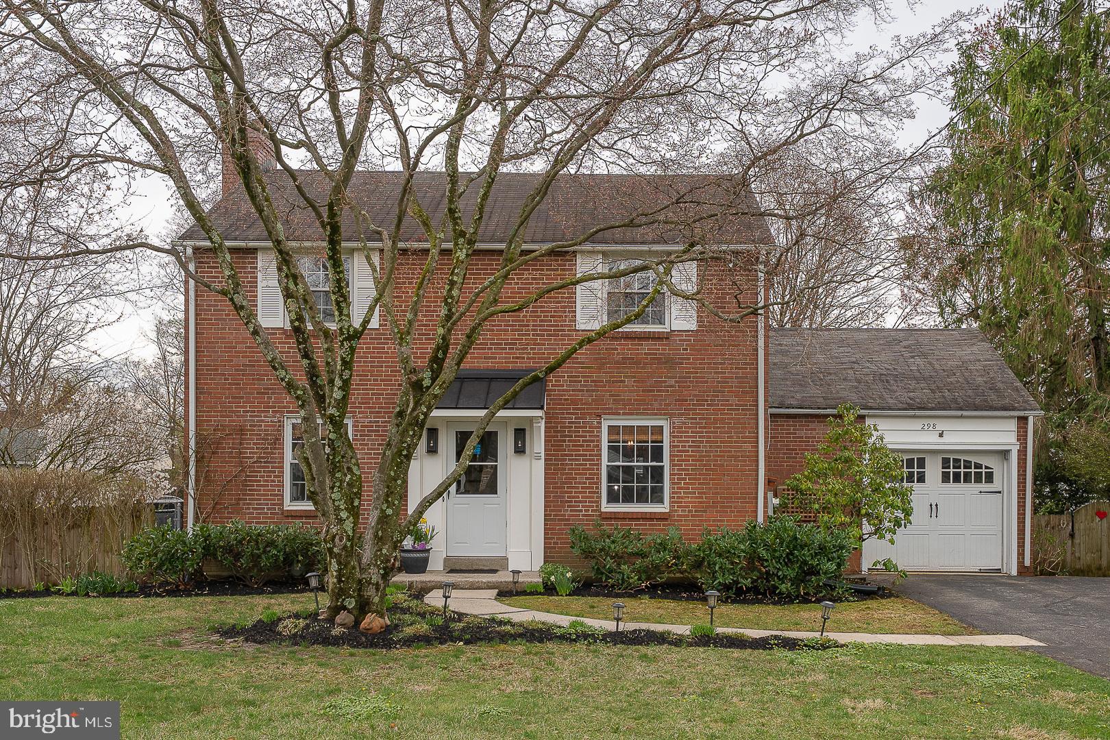298 Strafford Avenue Wayne, PA 19087 - Photo 2 of 41 a front view of a house with a yard and a tree