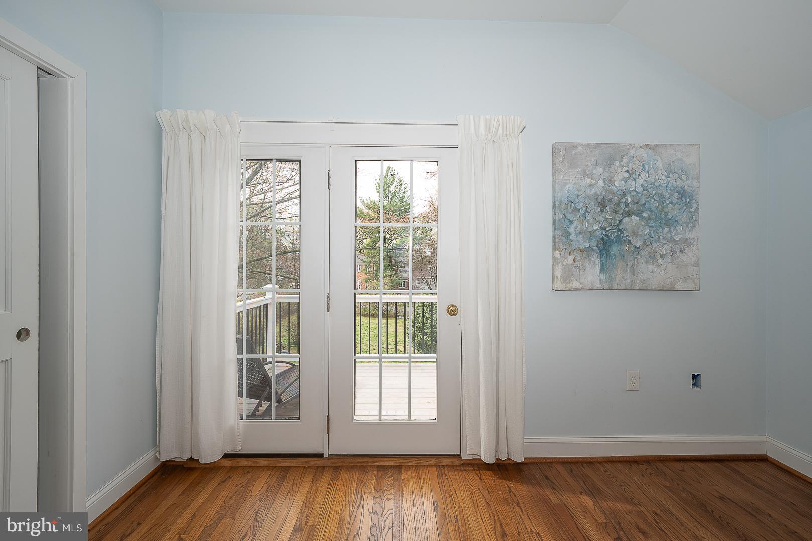 298 Strafford Avenue Wayne, PA 19087 - Photo 25 of 41 an empty room with wooden floor and windows