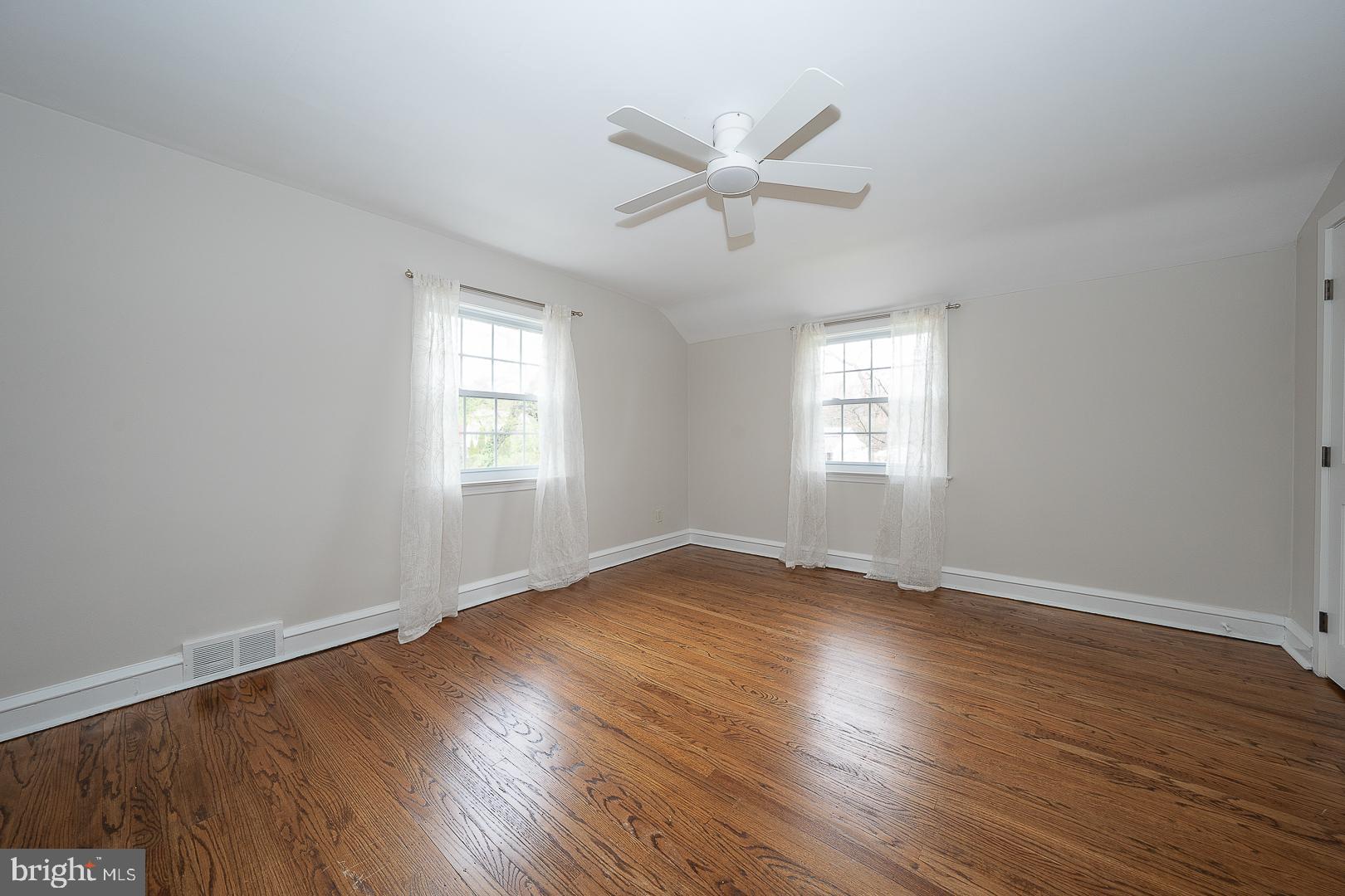 298 Strafford Avenue Wayne, PA 19087 - Photo 31 of 41 a view of an empty room with wooden floor and a window