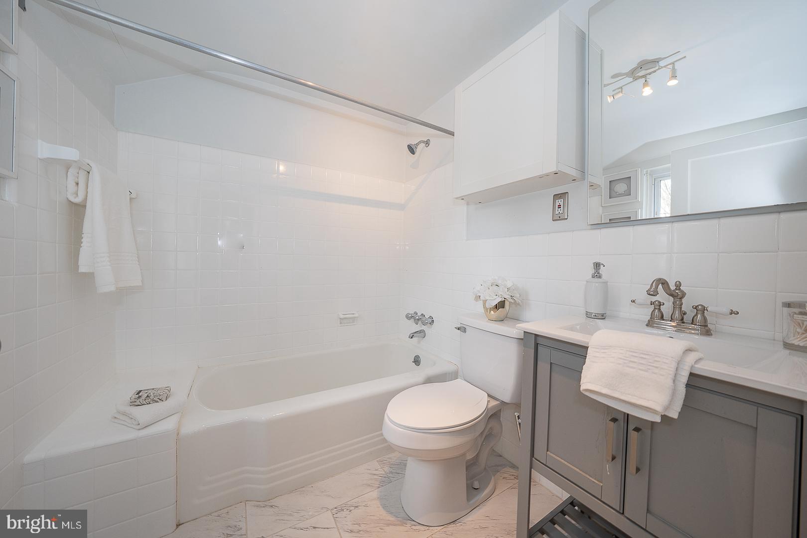 298 Strafford Avenue Wayne, PA 19087 - Photo 36 of 41 a bathroom with a toilet a sink a mirror and bathtub