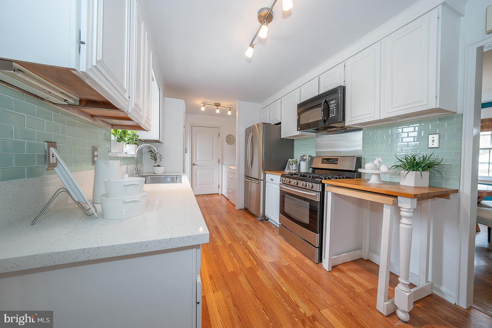 298 Strafford Avenue Wayne, PA 19087 - Photo 10 of 41 a kitchen with stainless steel appliances granite countertop a sink a stove and a wooden floors
