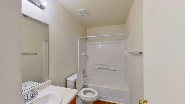 a bathroom with a shower a toilet and a shower