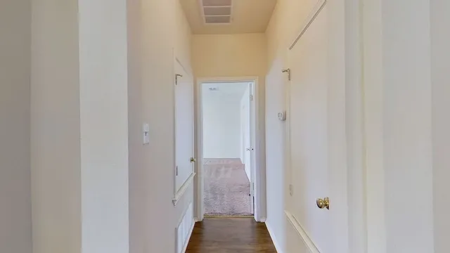 a view of a bathroom from a hallway