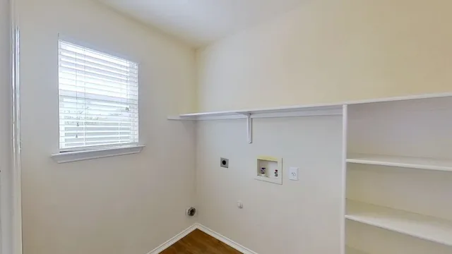 a view of room with hardwood floor and window