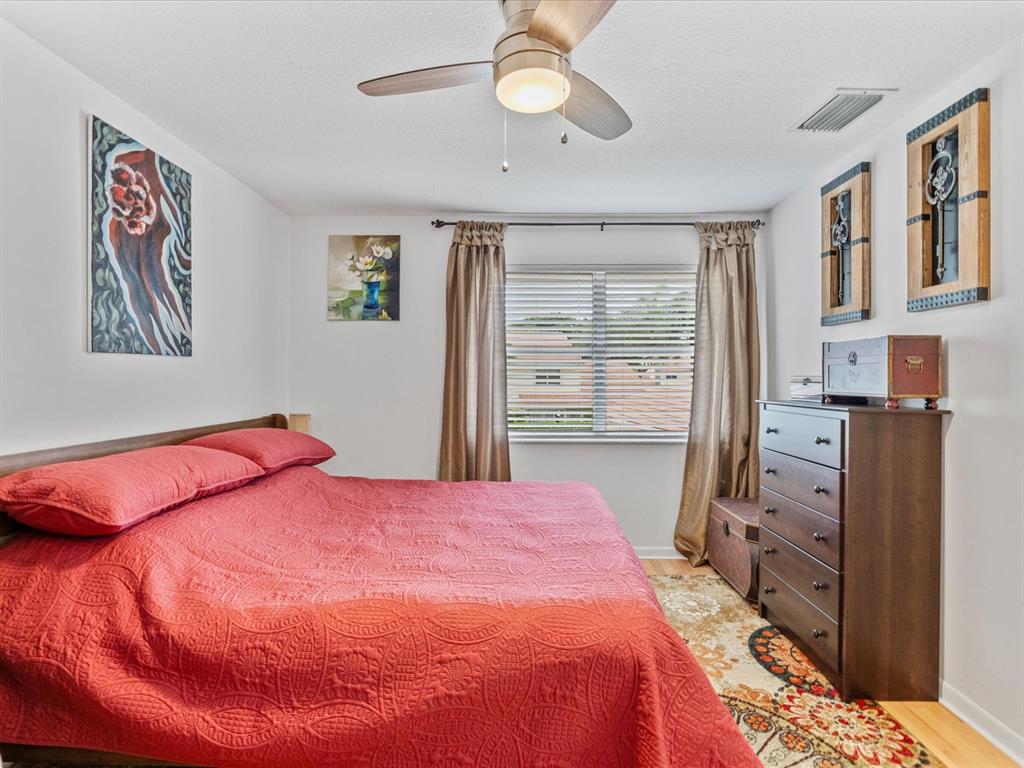 6273 Walk Circle Boca Raton, FL 33433 - Photo 17 of 25 a bedroom with a bed and a chandelier