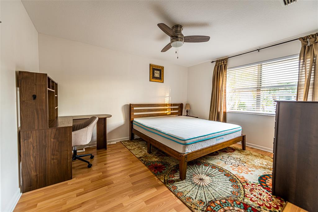 6273 Walk Circle Boca Raton, FL 33433 - Photo 18 of 25 a bedroom with a bed and wooden floor