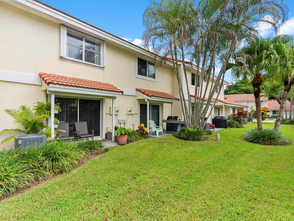 6273 Walk Circle Boca Raton, FL 33433 - Photo 21 of 25 a front view of a house with garden and porch