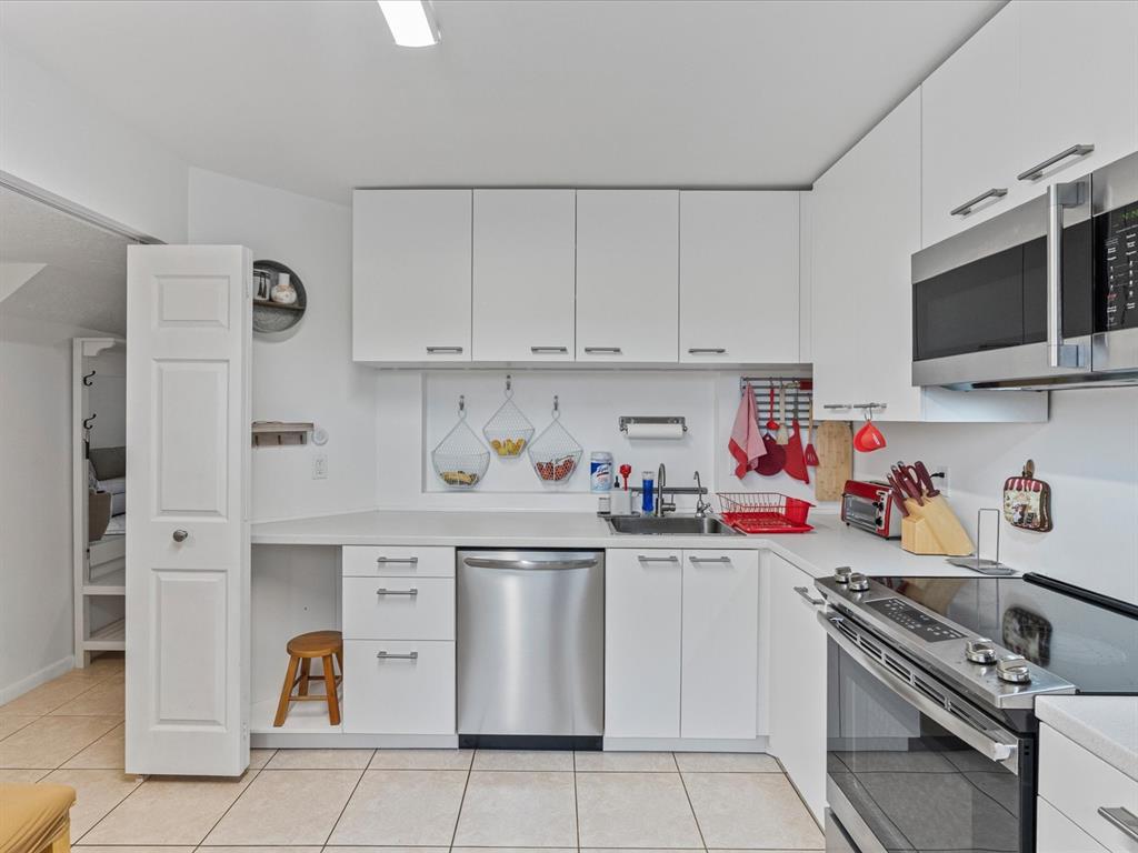 6273 Walk Circle Boca Raton, FL 33433 - Photo 4 of 25 a kitchen with stainless steel appliances granite countertop a refrigerator and a stove top oven