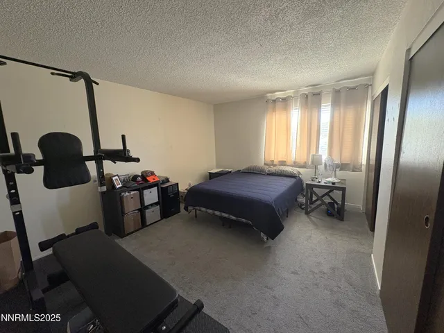 a bedroom with furniture and a window