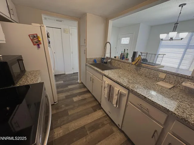 a bathroom with sink shower and mirror