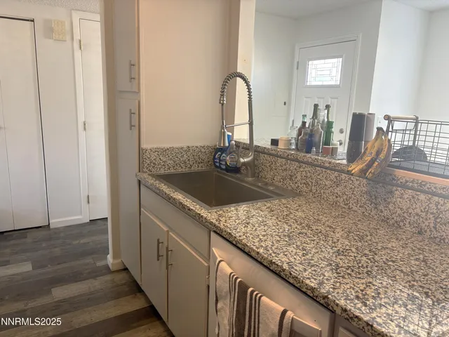 a kitchen with sink and mirror