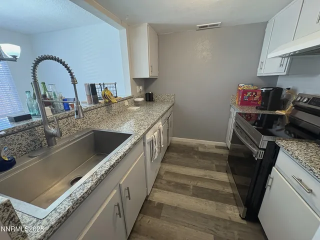 a kitchen with a sink and a stove top oven