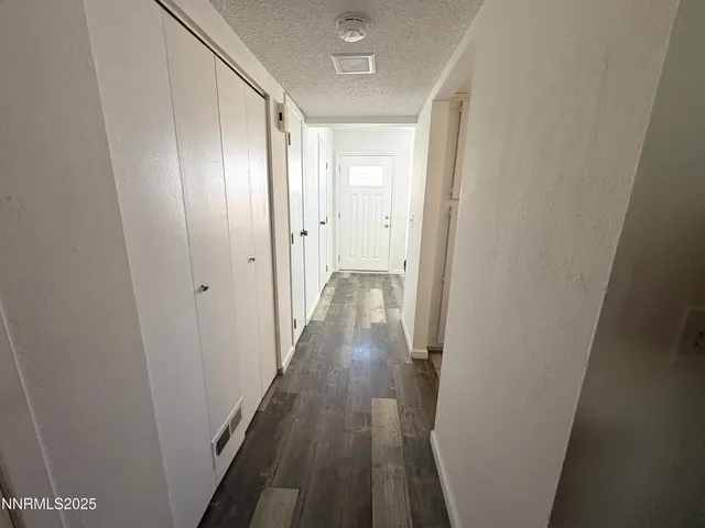 a view of a hallway with wooden floor