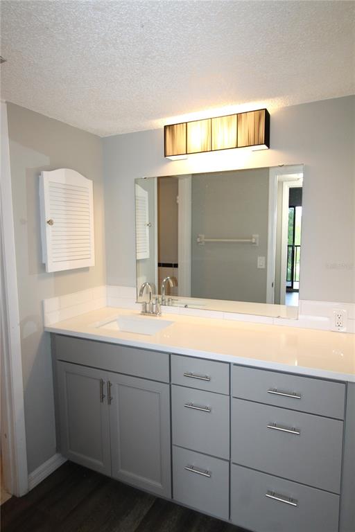 4119 61st Ave Terrace West, Unit 407 Bradenton, FL 34210 - Photo 14 of 19 a bathroom with a sink and a mirror