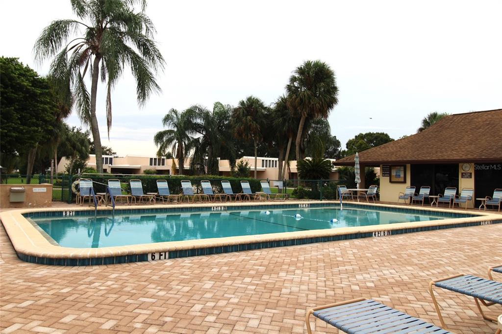 4119 61st Ave Terrace West, Unit 407 Bradenton, FL 34210 - Photo 18 of 19 a view of a swimming pool with a house