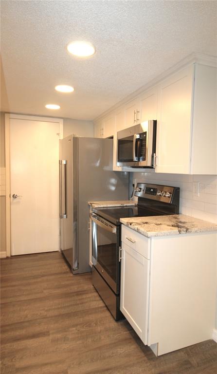 4119 61st Ave Terrace West, Unit 407 Bradenton, FL 34210 - Photo 2 of 19 a kitchen with a stove and a refrigerator