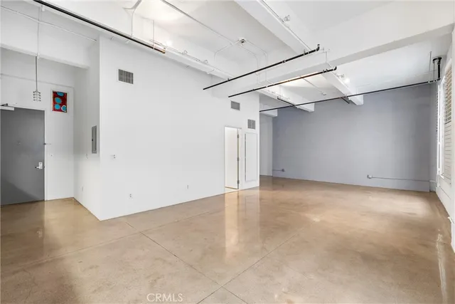 a kitchen with stainless steel appliances granite countertop a refrigerator a stove top oven and a sink with granite countertops