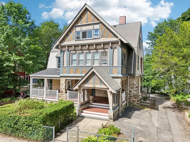 a view of house with yard and sitting area