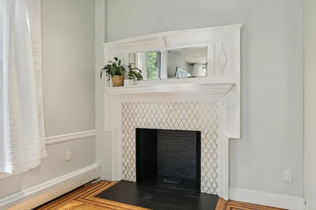 a hallway with a fireplace and wooden floor